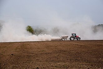 Rock dust , Spreading lime at Aghnahoo by Kenneth Allen, CC BY-SA 2.0 <https://creativecommons.org/licenses/by-sa/2.0>, via Wikimedia Commons